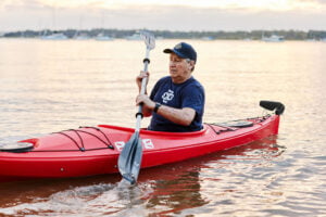 Bill Van Neirop kayaking in the river